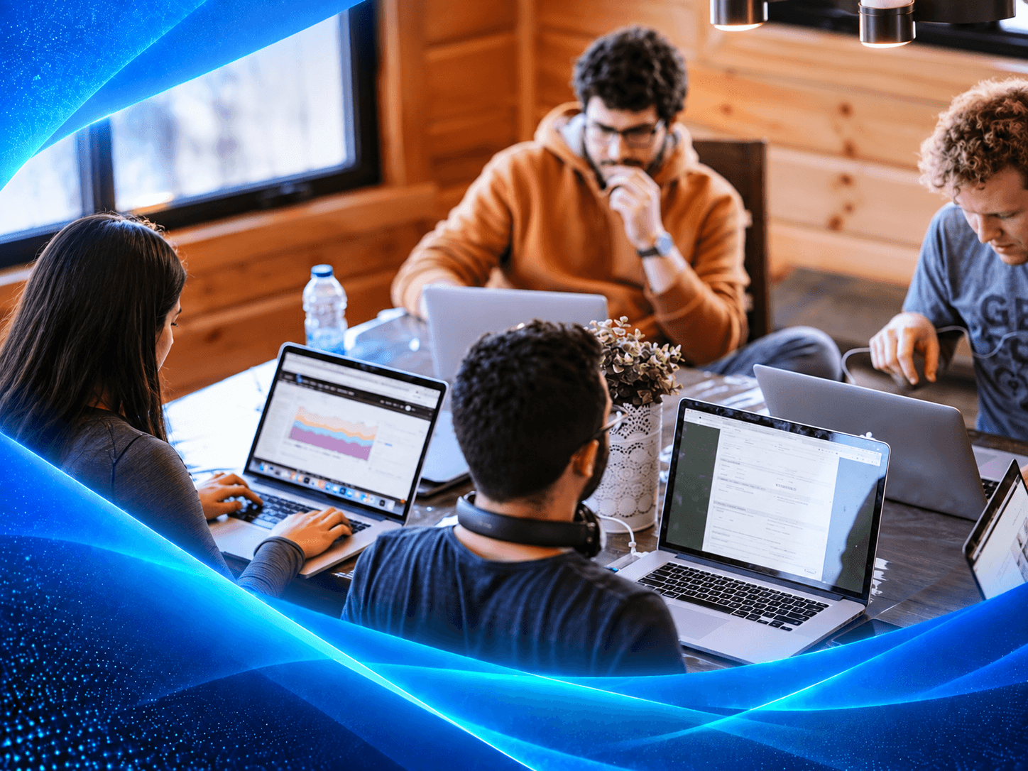 A FORTE delivery team working together over laptops around a shared table